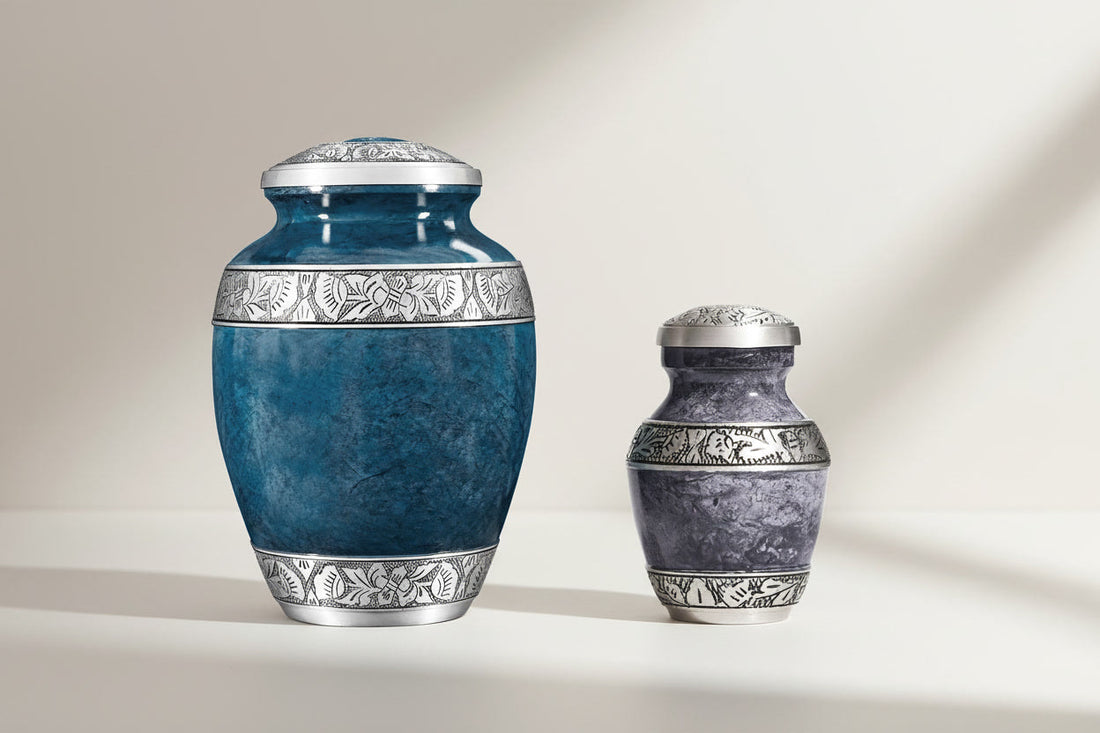 Large adult 200 cu in handcrafted aluminum cremation urn with blue-green marbled finish next to matching smaller keepsake urn on clean studio background
