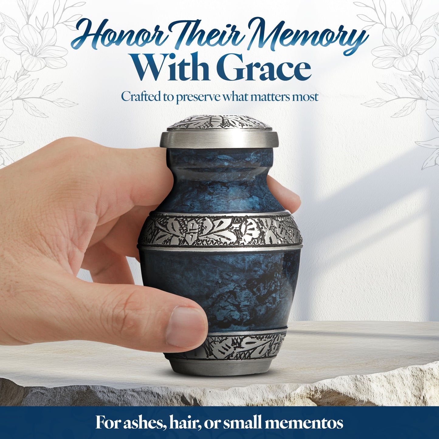 Blue keepsake urn held in hand showing elegant marbled finish and hand-engraved details